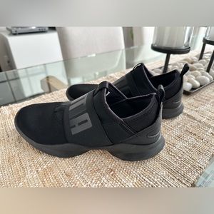 Barely worn women’s black slip on Puma sneakers